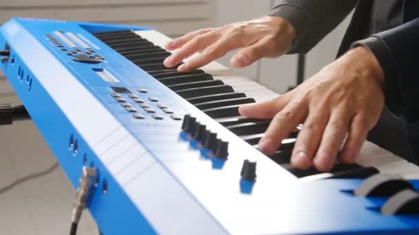 Concept of music and live concerts. Hands of musician playing keyboard in concert — Stock Video
