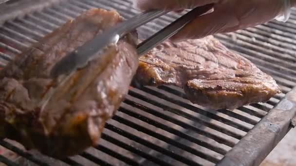 Cooking concept. Two grilling steaks on flaming grill — Stock Video