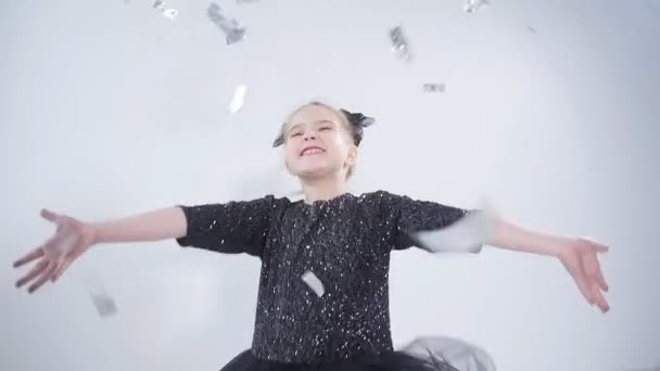 Concept of holiday and party. Happy little girl throwing confetti — Stock Video