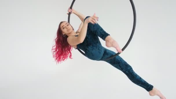 Concept of dance and gymnastics. Young beautiful woman on aerial hoop on a white background — Stock Video