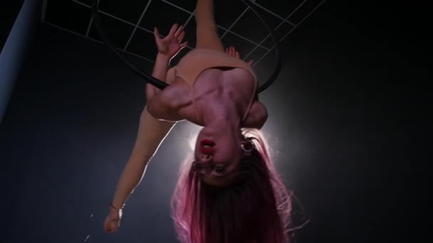 Concept of dance and acrobatics. Young beautiful woman in aerial hoop with color backlight — Stock Video