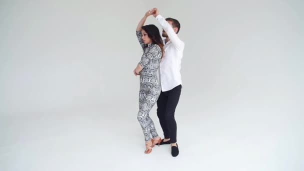 Concept of love, relationships and social dancing. Social dance, salsa, zouk, tango, kizomba concept - beautiful couple dancing bachata — Stock Video