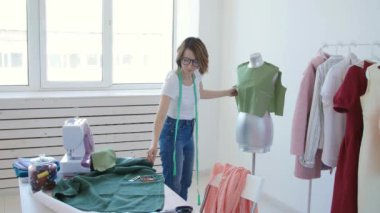 Terzi, terzi ve moda konsepti - Stüdyoda işyerinde kadın giyim tasarımcısı