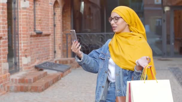 Jonge gelukkige mooie moslim vrouw die selfie op straat neemt — Stockvideo