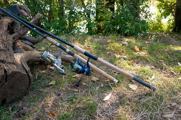 Fishing rods with reels on the natural background. — Stock Photo, Image