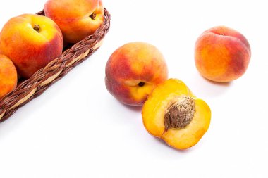 Bütün ve olgun şeftali meyve yarısı ve sepet izole içinde birkaç