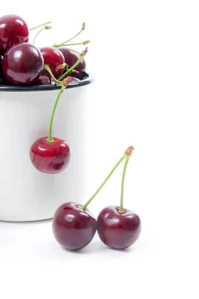 White cup with red sweet cherry isolated on a white background — Stock Photo, Image