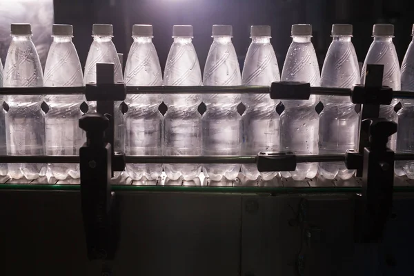 Closeup on mineral water bottles in raw and lines