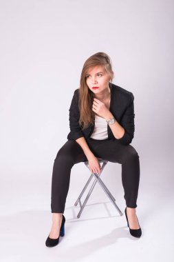 Studio, beyaz arka plan üzerinde izole resmi takım elbise poz esmer saçlı beyaz çekici kadın modeli