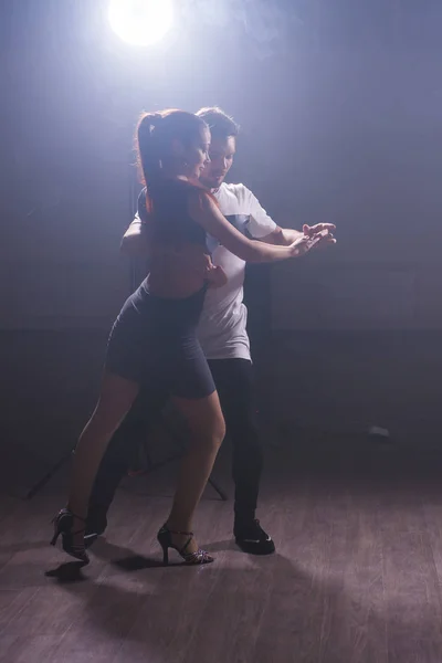 stock image Young couple dancing latin dance Bachata, merengue, salsa. Two elegance pose in dance class