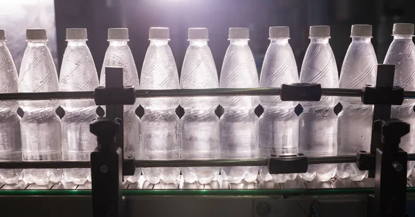 Closeup on mineral water bottles in raw and lines