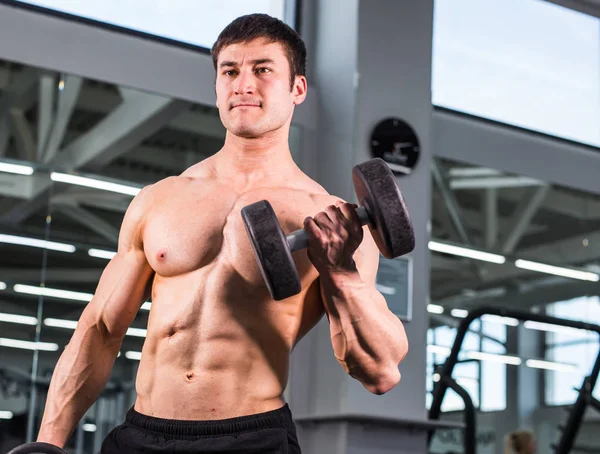 Schöner Bodybuilder Mann mit großen Muskeln in der Turnhalle — Stockfoto