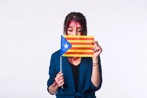 The victim woman holds the flag of Catalonia. Protest against terrorism.