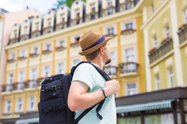 Turistik bir şapka ve tarihi binalar arasında seyir çevrede sırt çantası