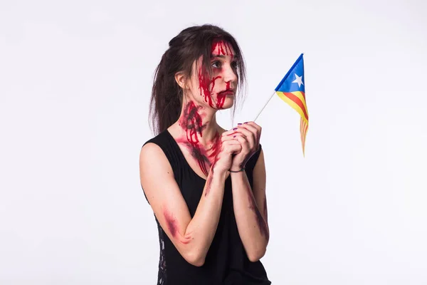 The victim woman holds the flag of Catalonia. Protest against terrorism.