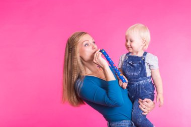 Tuhaf ailenin pembe bir arka plan üzerinde. Anne ve kızı kızı. Anne ve çocuk eğleniyor musun.