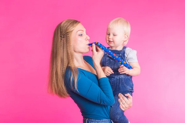 Moeder en dochter plezier geïsoleerd op roze achtergrond — Stockfoto