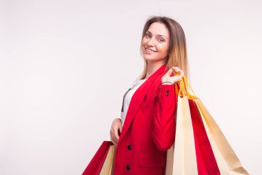 Sırtındaki kopya alanı ile alışveriş torbaları ile kırmızı ceketli güzel kadın portresi
