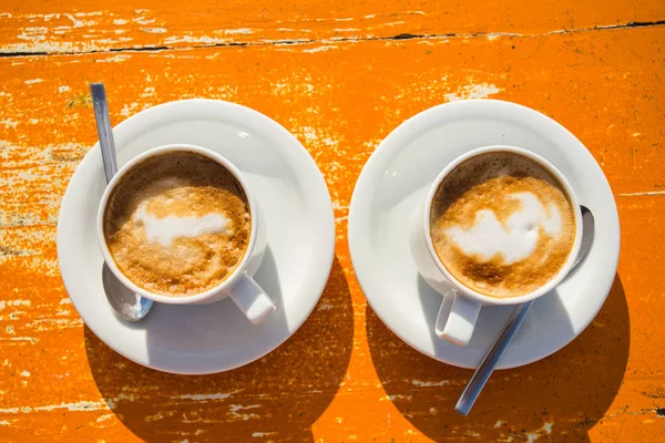 Two invigorating cappuccinos on the table await you, top view — Stock Photo, Image