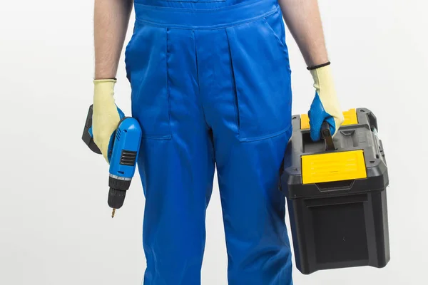 Construction, building and workers concept - Close-up of builder holding toolbox and screwdriver on white background — Stock Photo, Image