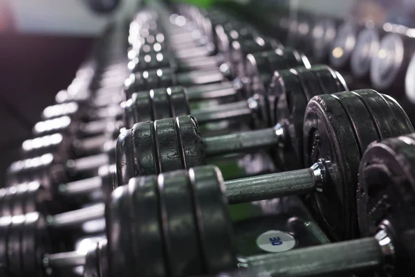 Black dumbbell set in sport fitness center. Weight Training Equipment concept. — Stock Photo, Image