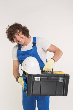 İnşaat, yapı ve işçi kavramı - kask ve kameraya gülme araç kutusu ile mutlu yakışıklı Oluşturucu.