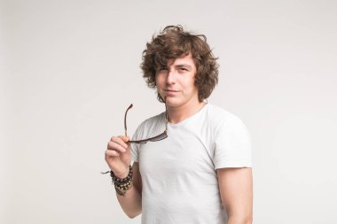 Beyaz arka plan üzerinde beyaz t-shirt gözlüklü cool adam portresi