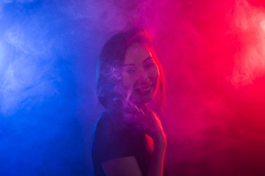 Genç kadın sigara vape veya e-sigara neon ışık
