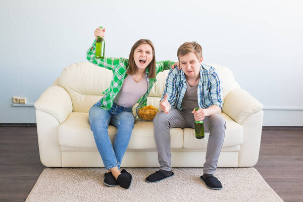 Soccer world cup concept - Modern couple looking excited and happy watching sport game on tv