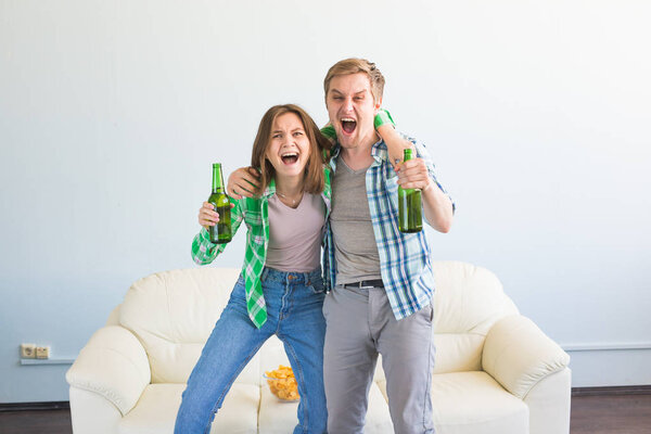 Soccer world cup concept - Modern couple looking excited and happy watching sport game on tv