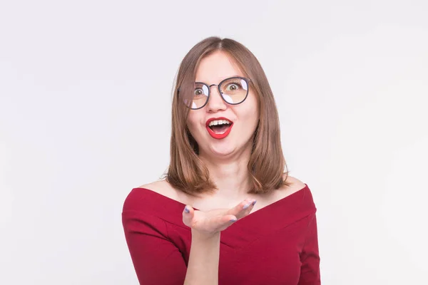 Retrato de chica divertida en gafas soplando beso con labios rojos en fondo blanco . — Foto de Stock