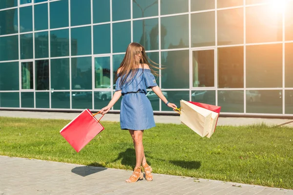 Glückliche Frau mit Einkaufstaschen beim Einkaufen. Konsum, Shopping, Lifestylekonzept — Stockfoto