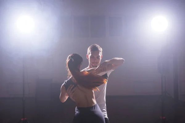 Active happy adults dancing bachata together in dance class