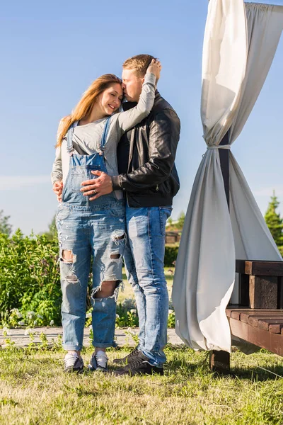 Concetto di famiglia, gravidanza e persone - Donna incinta con marito in natura — Foto Stock