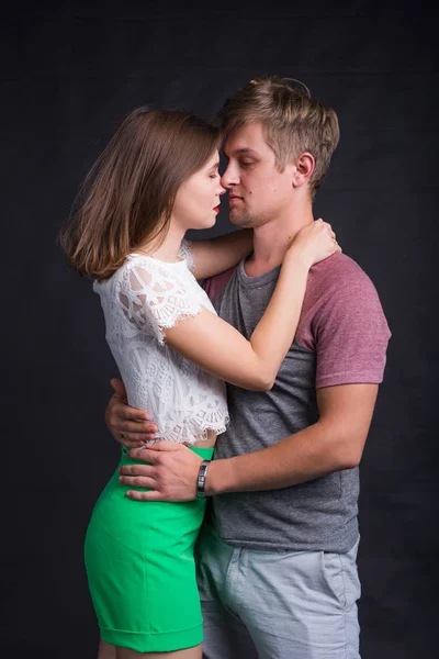 Jóvenes apasionados enamorados sobre fondo negro — Foto de Stock