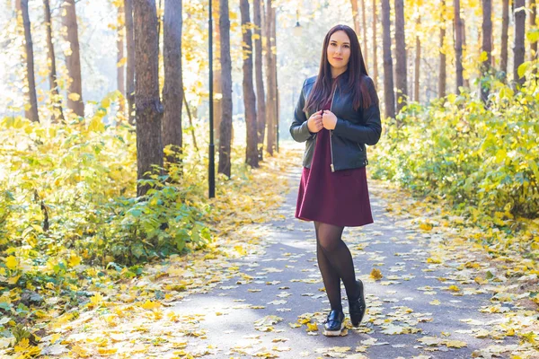 Gente, estación y concepto de la naturaleza - Mujer joven caminando en el parque de otoño —  Fotos de Stock
