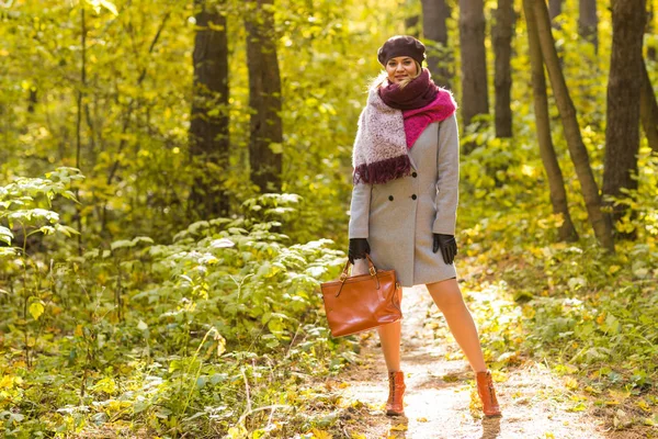 Conceito de queda, natureza e pessoas - Jovem mulher bonita de casaco cinza em pé no parque de outono — Fotografia de Stock