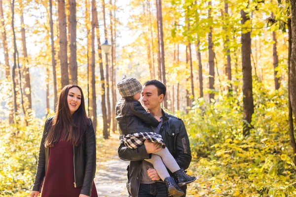 Children, nature and family concept - Portrait of happy family over autumn park background — Stock Photo, Image