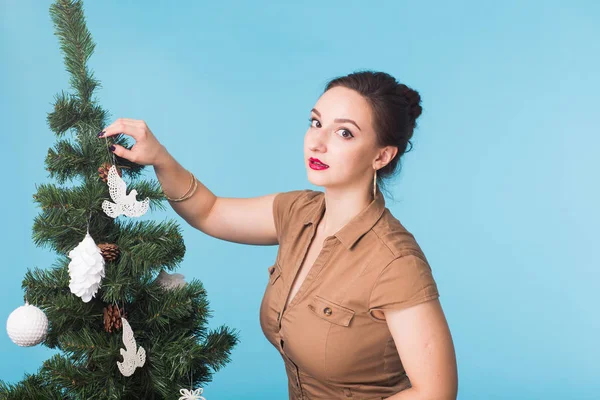 Γιορτή και αργία έννοια - πορτρέτο του χαμογελαστό κορίτσι με το χριστουγεννιάτικο δέντρο σε μπλε φόντο. — Φωτογραφία Αρχείου