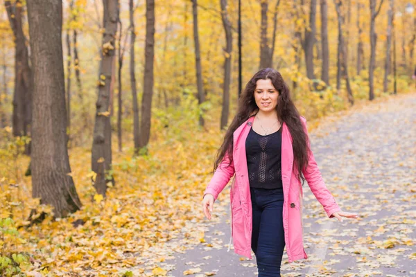 Season, fall and people concept - plus size woman walking in autumn park — Stock Photo, Image