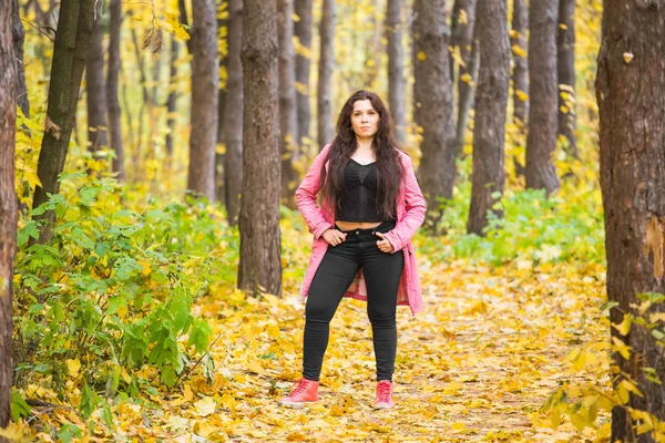Mens, seizoen en natuur concept - jonge vrouw lopen in herfst park — Stockfoto