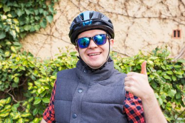 happyful cycling man in helmet and jacket, sunglasses clipart
