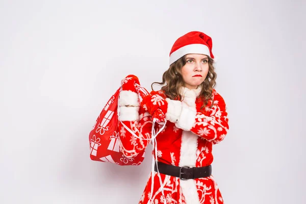 Διακοπές, Χριστούγεννα και άνθρωποι έννοια - θυμωμένη γυναίκα στο santa κοστούμι με τσάντα παρουσιάζει — Φωτογραφία Αρχείου