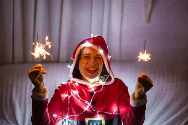 Natal, feriados e conceito de pessoas - jovem mulher feliz rindo em terno de Natal com luzes sobre o fundo branco — Fotografia de Stock