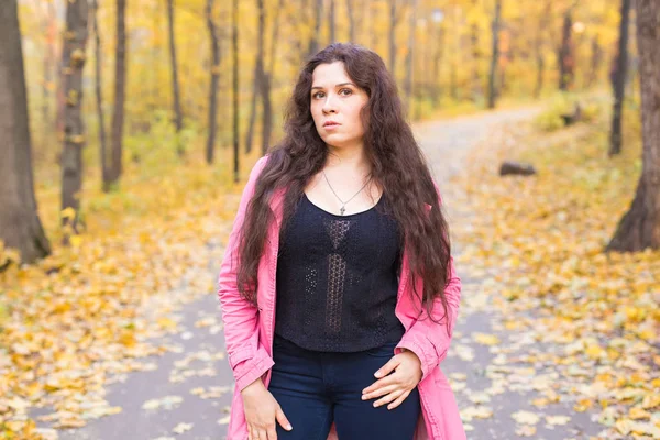 Nature, season and people concept - plus size woman smiling at the autumn park — Stock Photo, Image