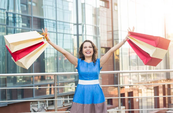 Konsum, Verkauf und Menschen-Konzept - glückliche junge Frau hat Spaß mit Einkaufstüten auf der Straße — Stockfoto