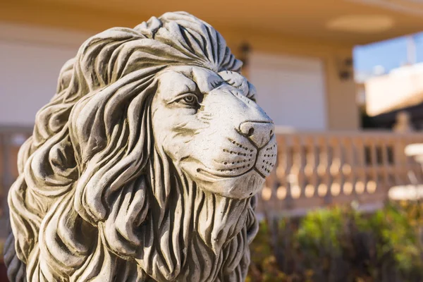 Stone lion statue. Marble Sculpture of a lion on pedestal