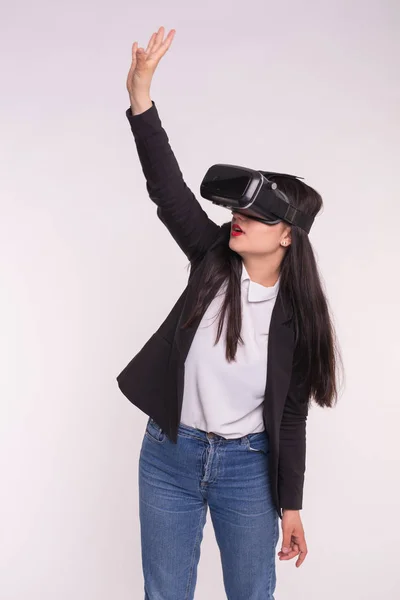 Asian woman playing game in virtual reality glasses.