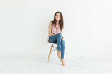 insanlar, güzellik ve moda kavramı - kopya alanı ile beyaz arka plan üzerinde izole sandalye poz genç esmer kadın