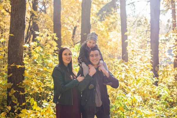 People, family and leisure concept - family having fun standing in autumn park